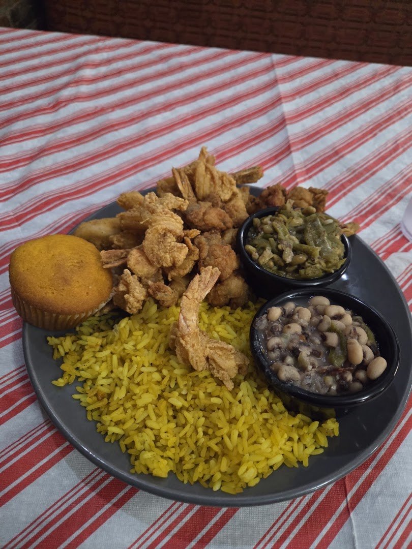 A warm plate with vegetables and fried meat.
